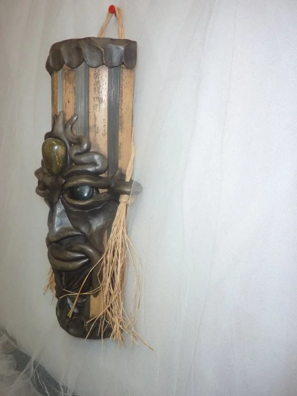 Clay mask on wood. Size 12 x 4 1/2 x 2 1/2 inches by artist Krisna Brasil